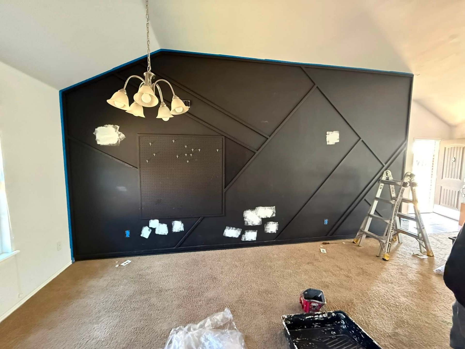 Geometric accent wall in progress with prep work visible