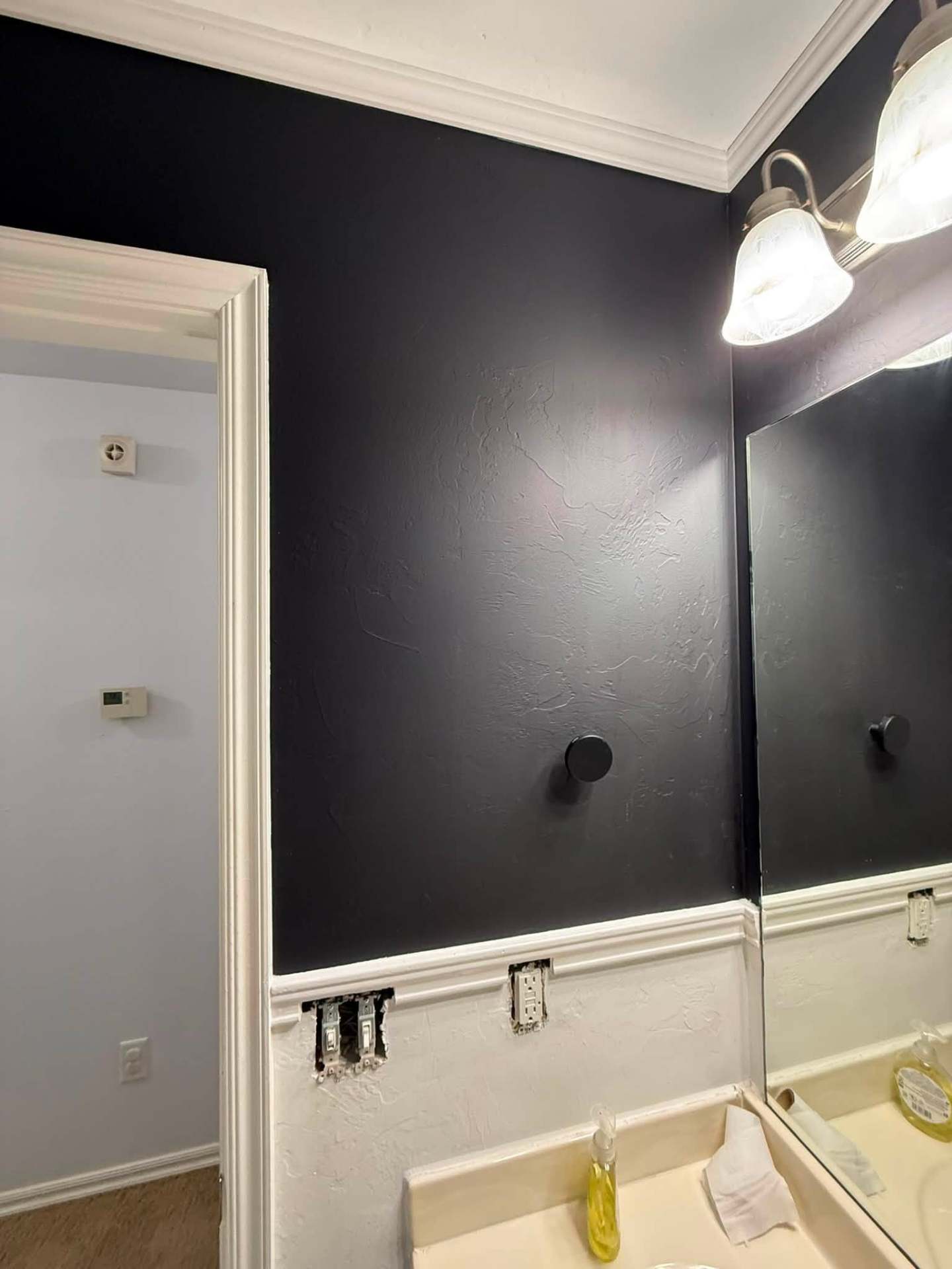 Vanity area painted in dark navy